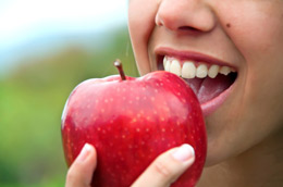 Tooth Implant in Chicago - Girl Biting an Apple