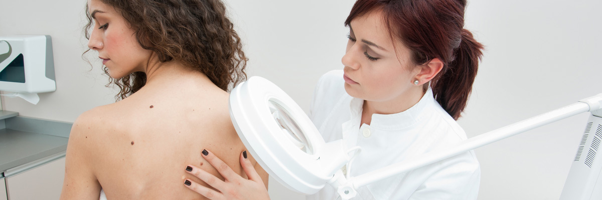 a woman getting checked for skin cancer
