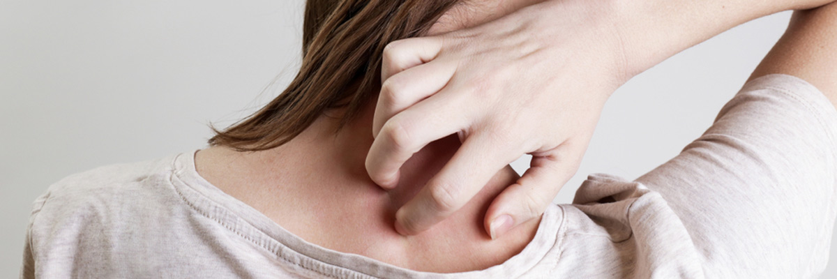 woman scratching her neck.