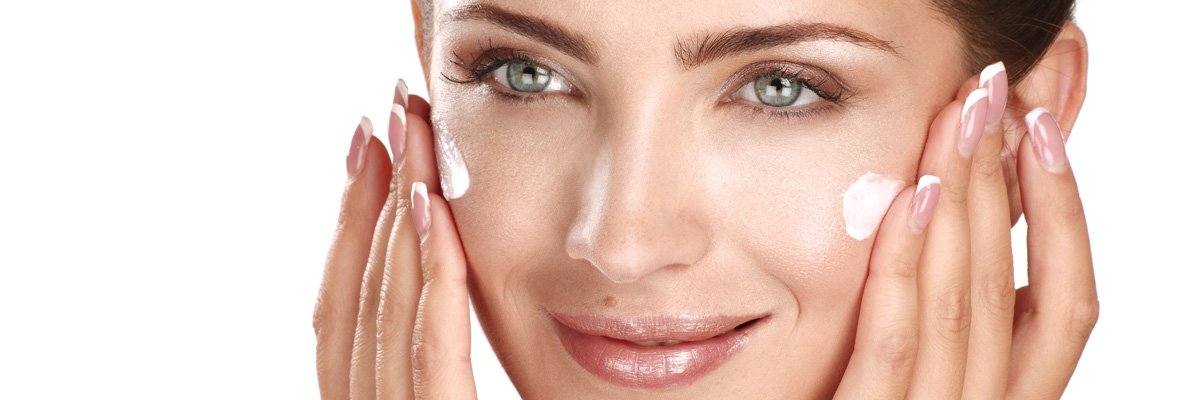 Beautiful Women applying cosmetic cream treatment on her face