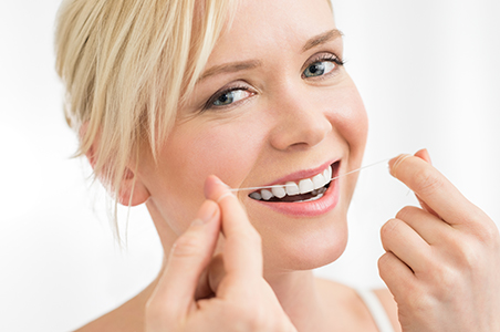 Close up of Woman Demonstrating Dental Floss, Preventive Dentistry Las Vegas