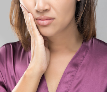 Beautiful young woman suffering from toothache