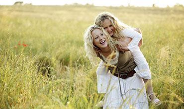 Mother and daughter playing in the field