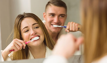 Couple brushing teeth