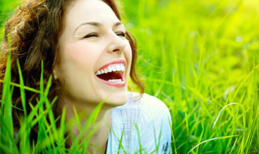 Smiling woman in a green field