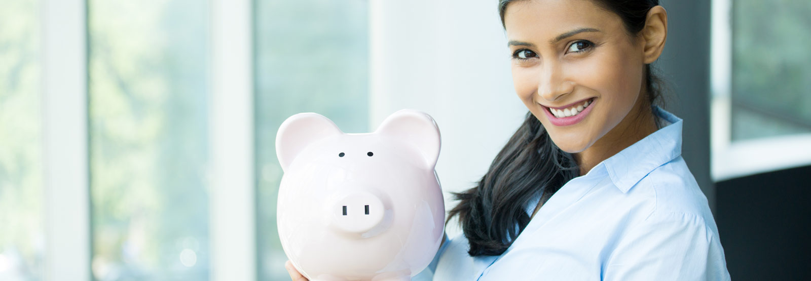 Woman, holding pink piggy bank