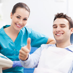 Man giving thumbs up at dentist office