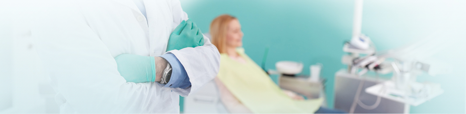 Male dentist with protecting equipment posing in dental clinic