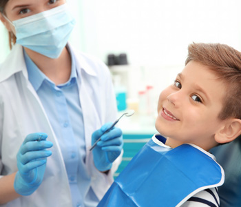Dentist examining little boy's teeth