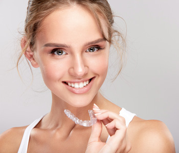 Woman holding invisible braces