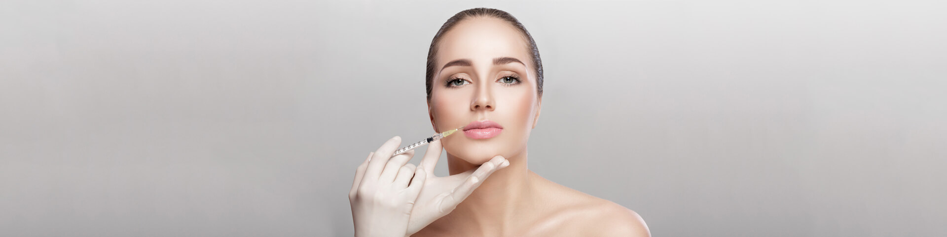 Portrait of beautiful woman getting injection on lips