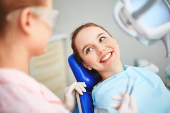 Patient smiling with dentist at dental office