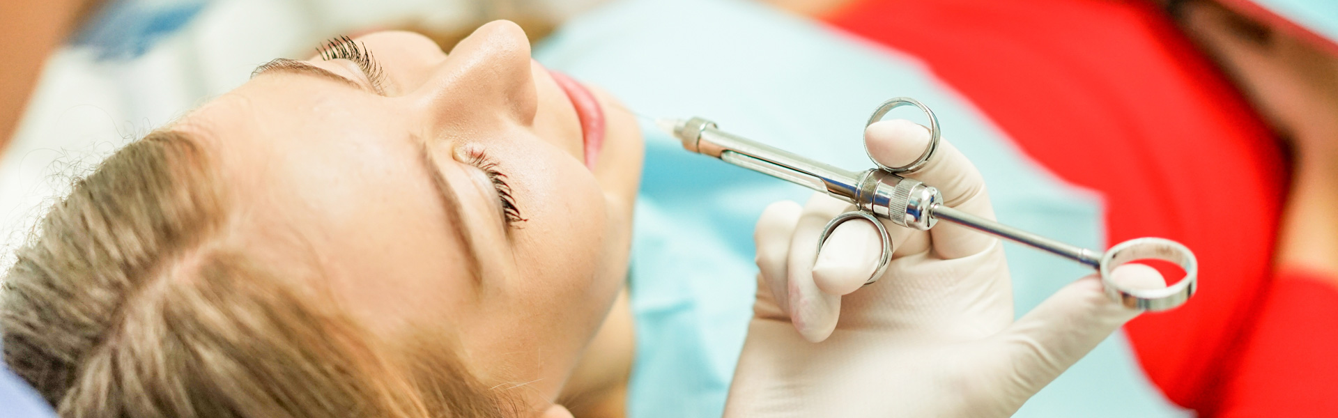 Doctor injects anesthesia to the young woman
