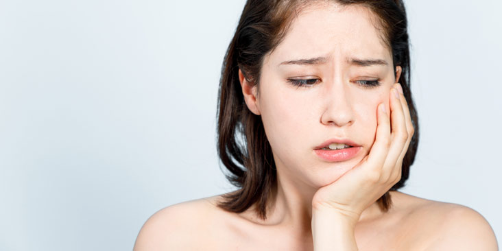 Young girl having a toothache.