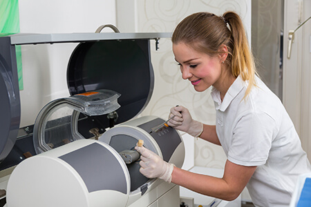 Dentist's assisstant operating CEREC Milling machine Dentist's assisstant operating CEREC Milling machine
