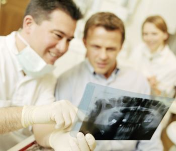 Dentists examining teeth x-ray